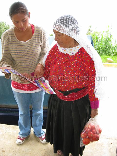 guide_chicometepec_17.JPG - My guide Olivia showing a poster of indigenous costume to my first participant, name unknown.